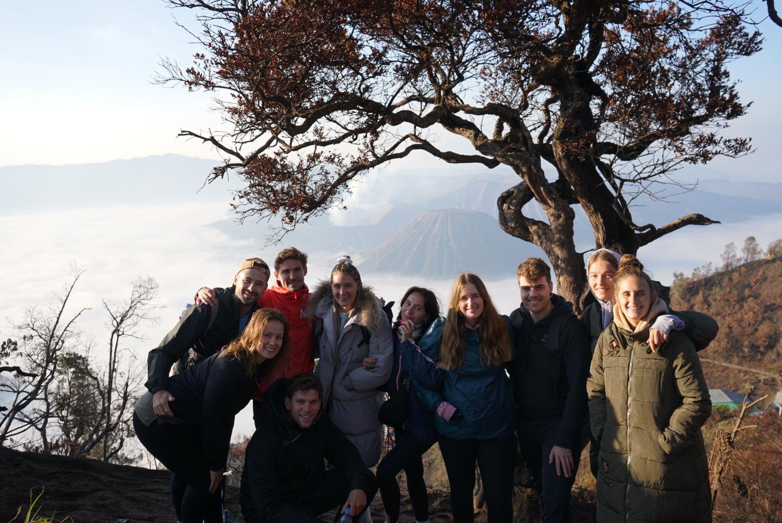Travelers at a sunrise viewpoint in the Mount Bromo area