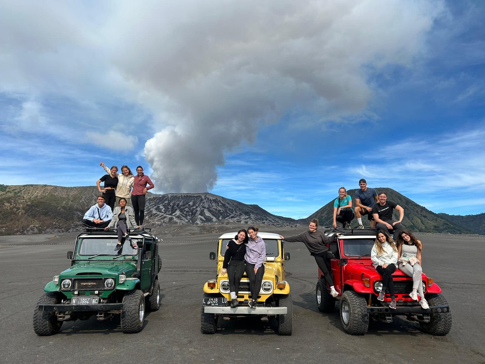 Travelers beside a jeep in the Mount Bromo Sea of Sand