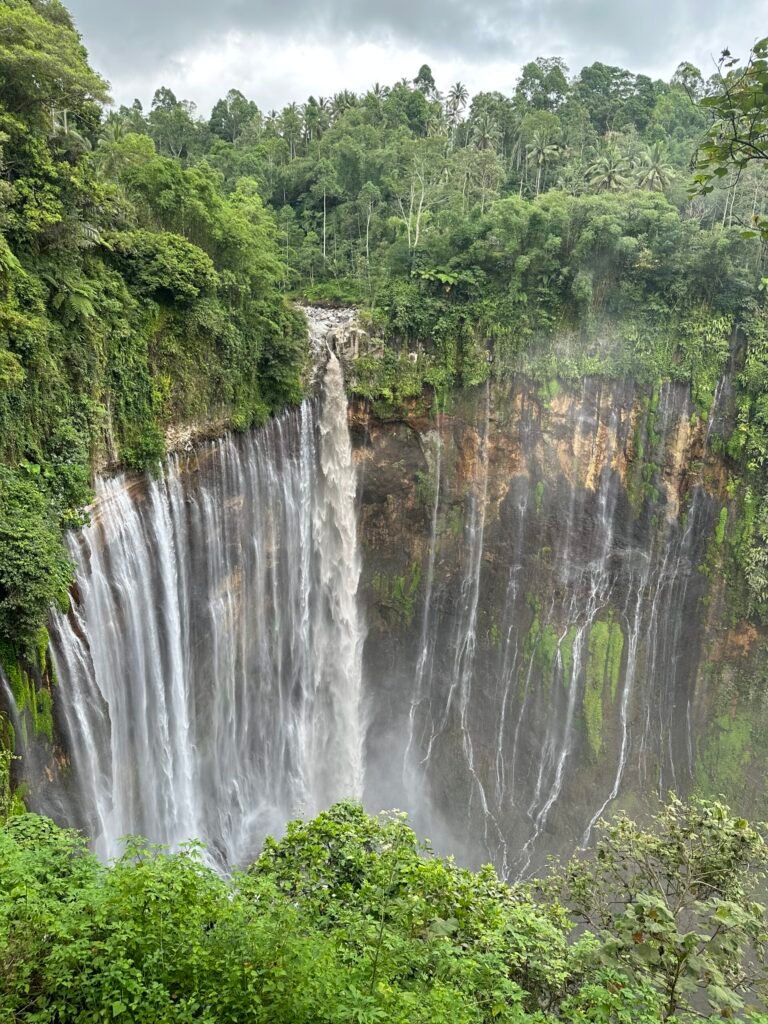 Wide view of Tumpak Sewu Waterfall in East Java, Indonesia