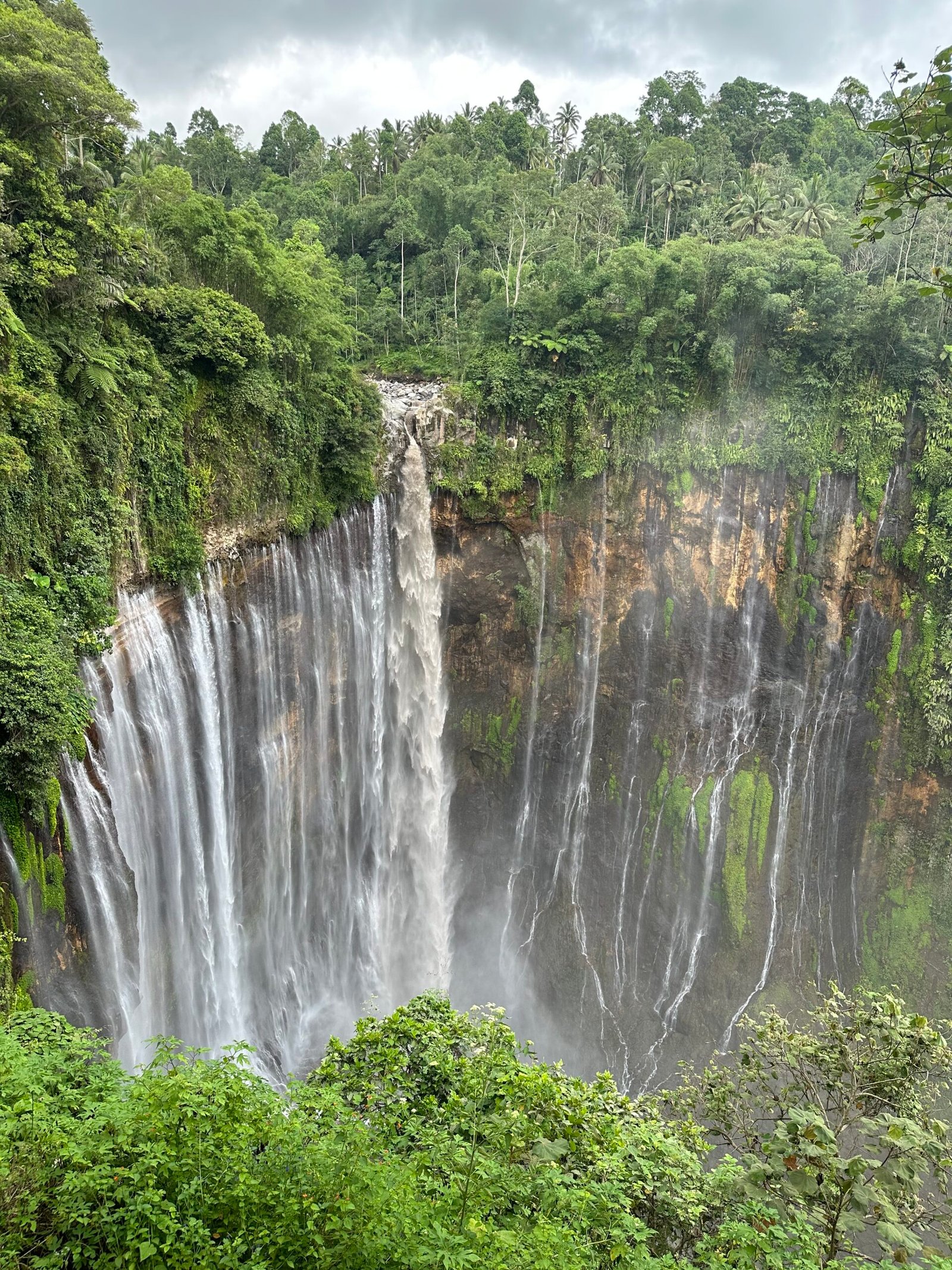 Wide view of Tumpak Sewu Waterfall in East Java, Indonesia