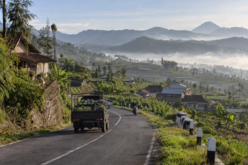 Overland road through East Java villages and volcanic highlands.