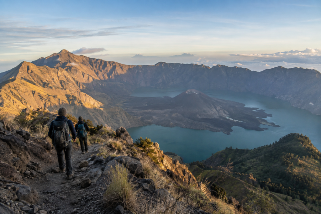 Trekkers overlooking Mount Rinjani crater and Segara Anak lake in Lombok.